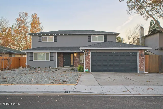 a front view of a house with garage