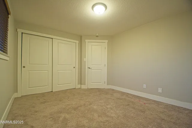 an empty room with closet area
