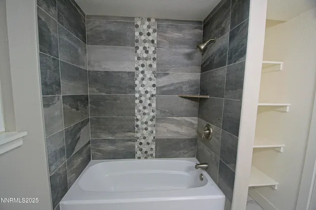 a bathroom with a bathtub and shower