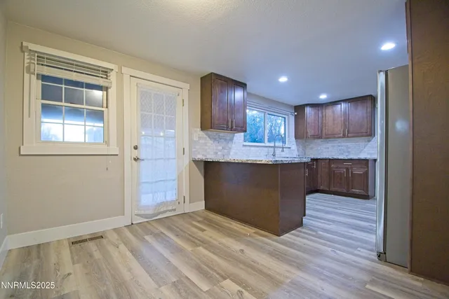 a view of kitchen and kitchen island wooden floor