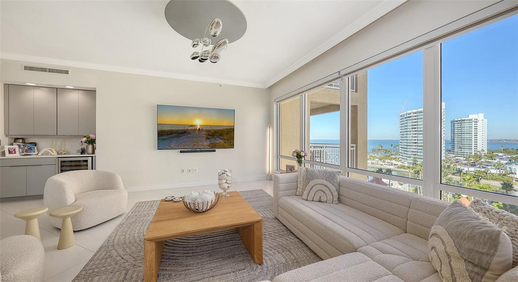 35 Watergate Drive, Unit 806 Sarasota, FL 34236 - Photo 11 of 67 a living room with furniture and a flat screen tv