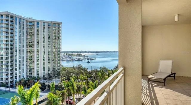 a living room with furniture a large window and a chandelier