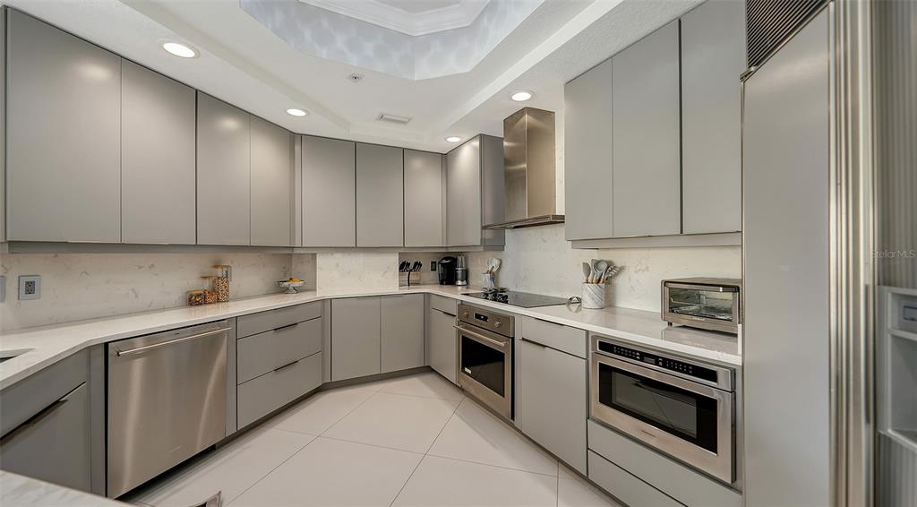 35 Watergate Drive, Unit 806 Sarasota, FL 34236 - Photo 30 of 67 a kitchen with white cabinets stainless steel appliances and sink