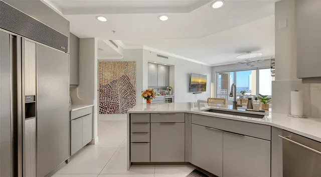 a bedroom with a large bed and a flat tv screen on a dresser