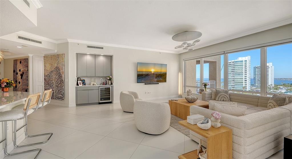 35 Watergate Drive, Unit 806 Sarasota, FL 34236 - Photo 38 of 67 a living room with furniture and a flat screen tv