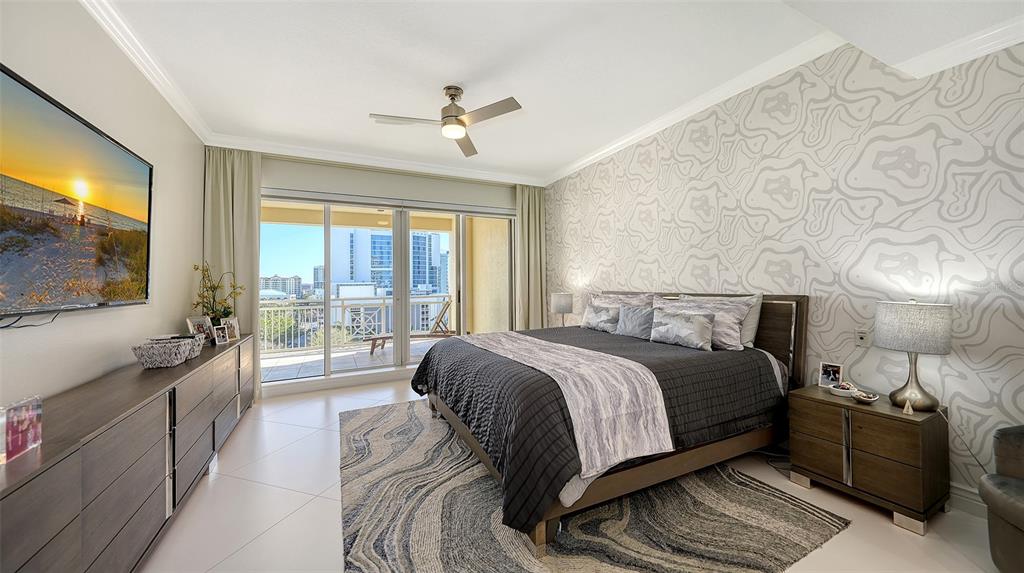 35 Watergate Drive, Unit 806 Sarasota, FL 34236 - Photo 39 of 67 a bedroom with a large bed and a flat tv screen on a dresser