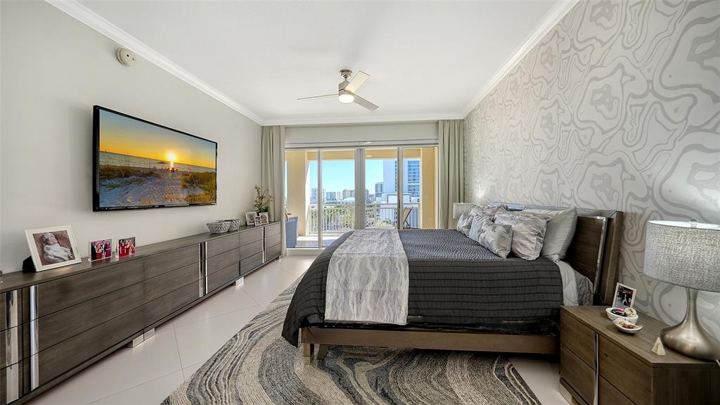 35 Watergate Drive, Unit 806 Sarasota, FL 34236 - Photo 40 of 67 a bedroom with a bed and a flat screen tv