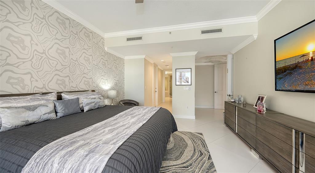 35 Watergate Drive, Unit 806 Sarasota, FL 34236 - Photo 41 of 67 a bedroom with a bed and a flat screen tv