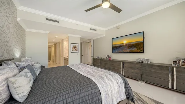 a bedroom with furniture and a flat screen tv