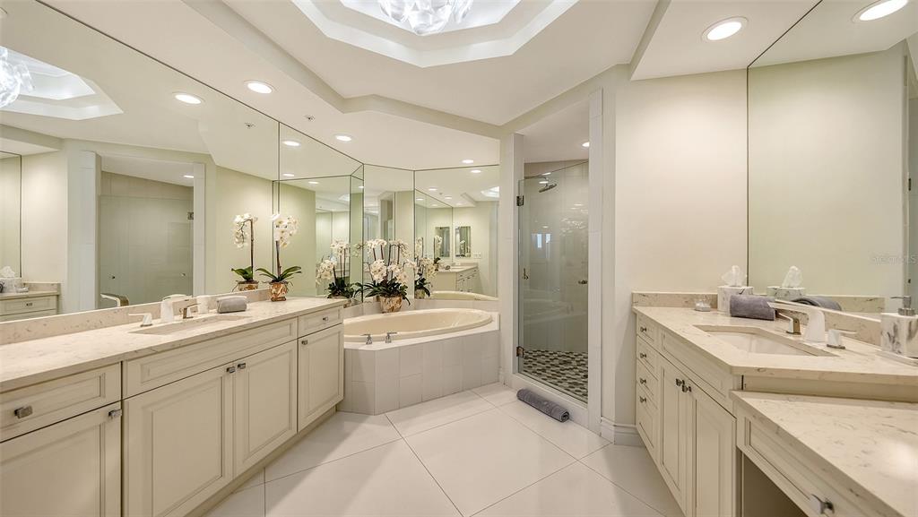 35 Watergate Drive, Unit 806 Sarasota, FL 34236 - Photo 44 of 67 a spacious bathroom with a double vanity sink mirror double and shower