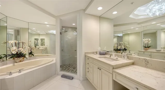 a view of ocean with boats and trees in the background