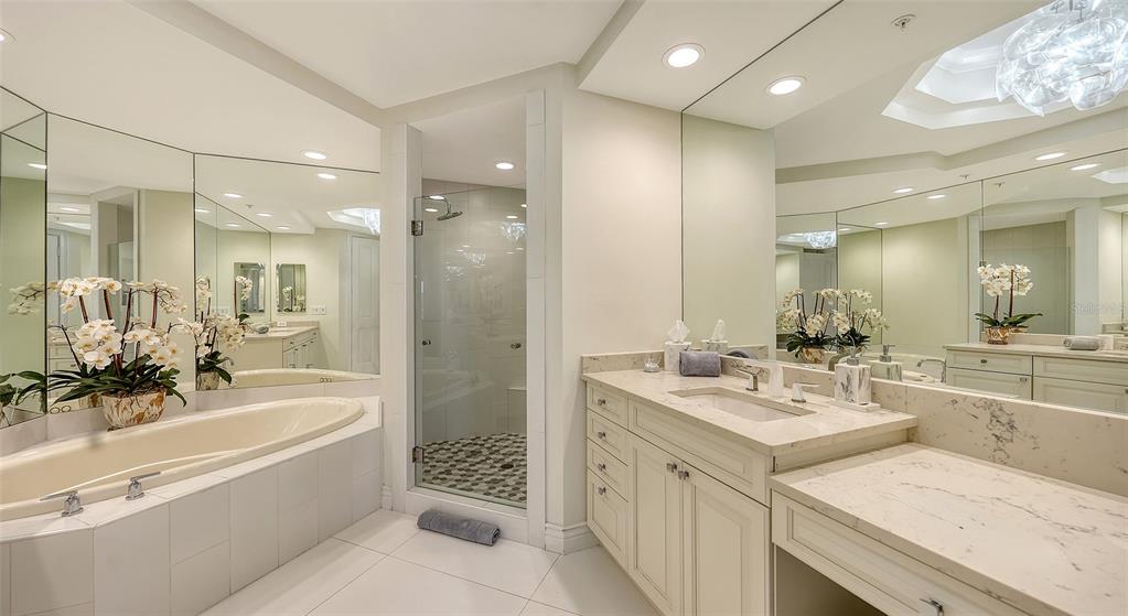 35 Watergate Drive, Unit 806 Sarasota, FL 34236 - Photo 46 of 67 a bathroom with a tub a sink shower and mirror
