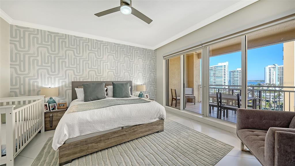 35 Watergate Drive, Unit 806 Sarasota, FL 34236 - Photo 48 of 67 a bedroom with a large bed and a balcony