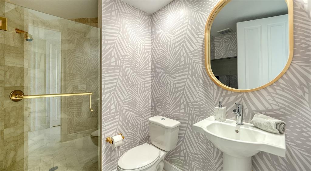 35 Watergate Drive, Unit 806 Sarasota, FL 34236 - Photo 53 of 67 a bathroom with a sink toilet and shower