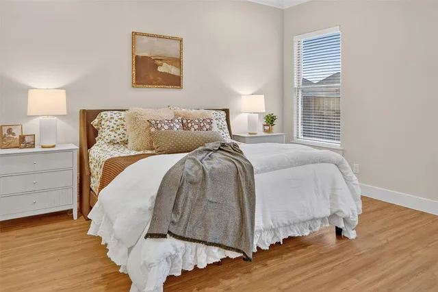 a bed sitting in a bedroom next to a window