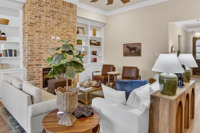 a living room with furniture a lamp and a potted plant