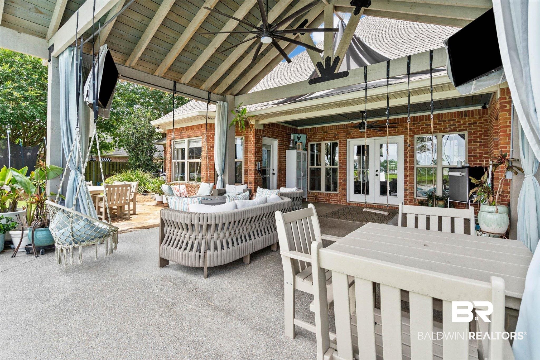 24908 Bosbyshell Avenue Daphne, AL 36526 - Photo 24 of 49 Expansive covered patio featuring a vaulted wood-slatted ceiling, ceiling fan, and multiple wall-mounted screens