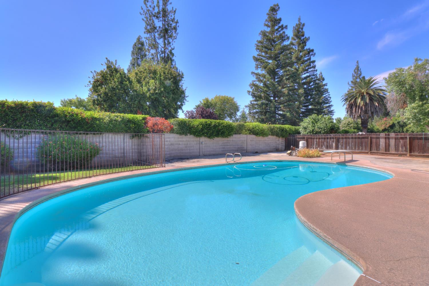 6265 North Colonial Avenue Fresno, CA 93704 - Photo 21 of 22 a view of a swimming pool with a yard