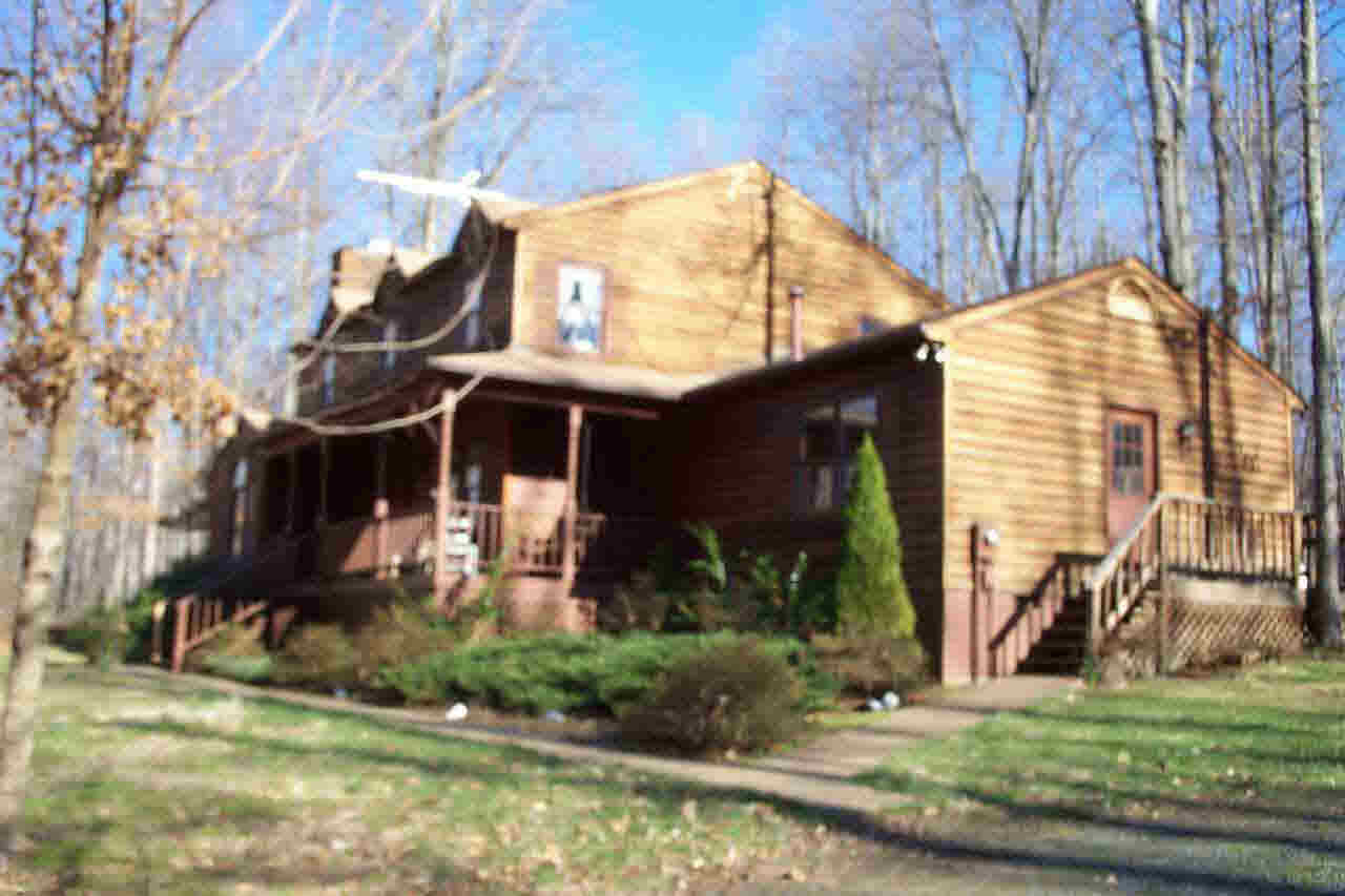 a view of a house with a yard and plants