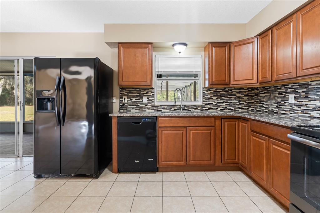 1033 Shore Acres Road Mount Dora, FL 32757 - Photo 11 of 48 Kitchen with granite counters and eat-in space