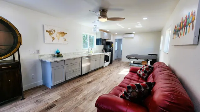 a blue couch sitting in a living room with a rug
