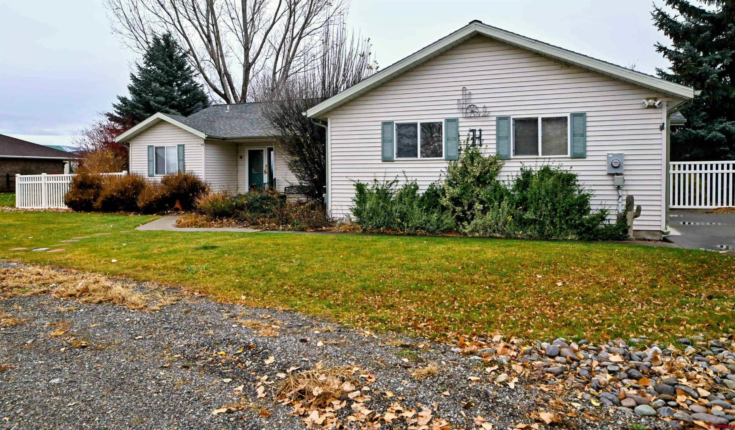 66750 Solar Road Montrose, CO 81403 - Photo 13 of 45 a front view of house with yard and green space