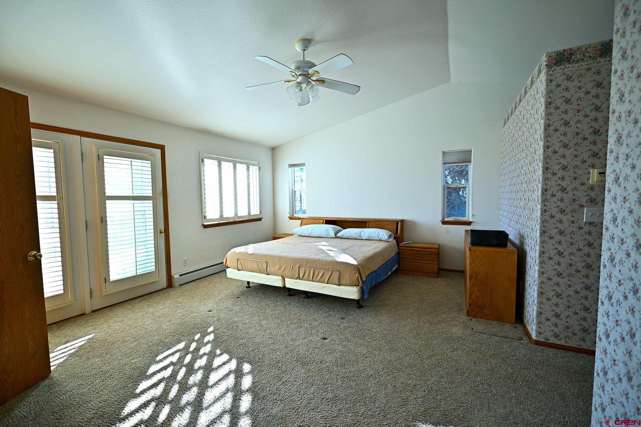 66750 Solar Road Montrose, CO 81403 - Photo 29 of 45 a bedroom with a bed and a chandelier