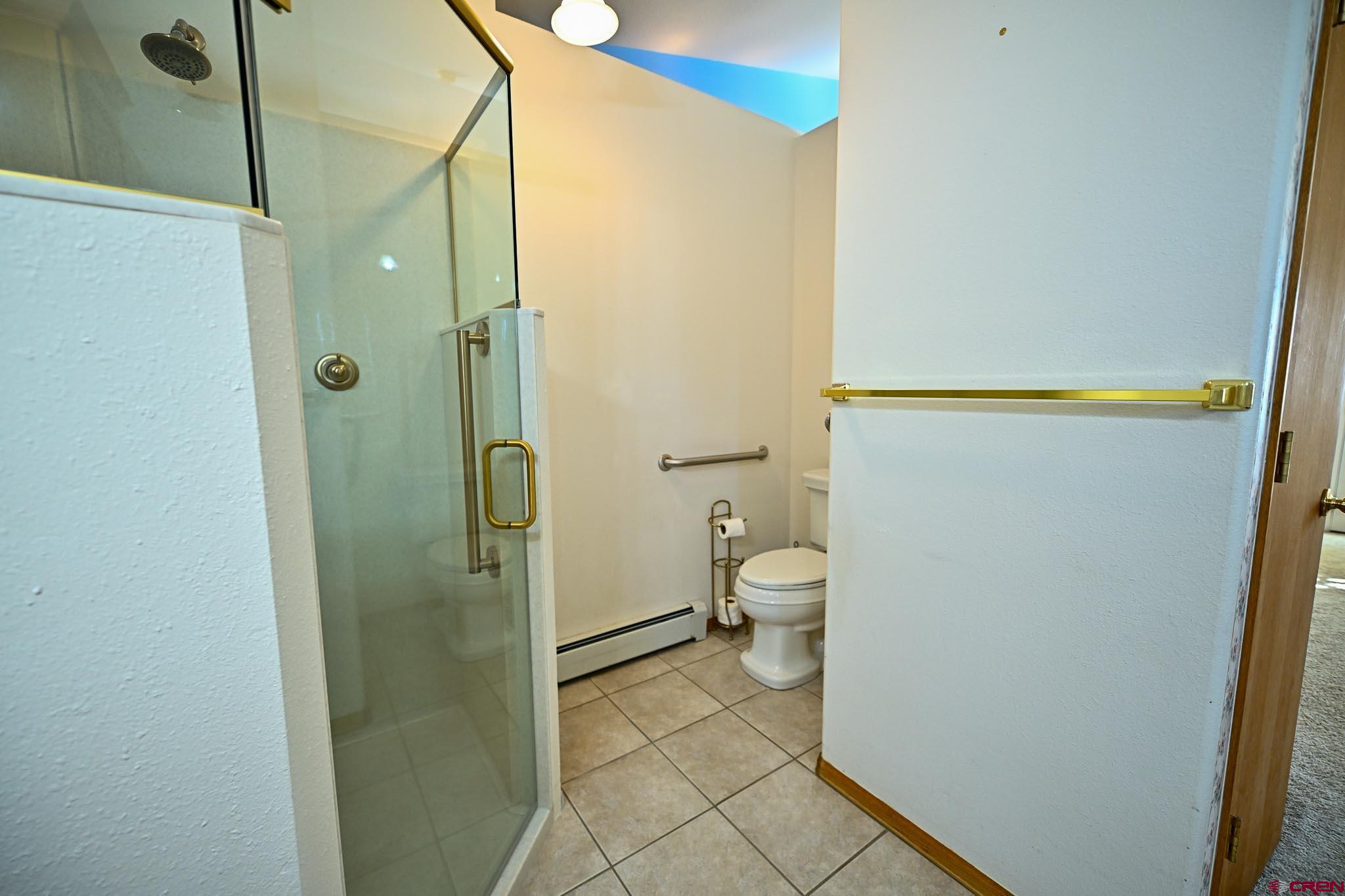 66750 Solar Road Montrose, CO 81403 - Photo 30 of 45 a bathroom with a granite countertop shower and a toilet