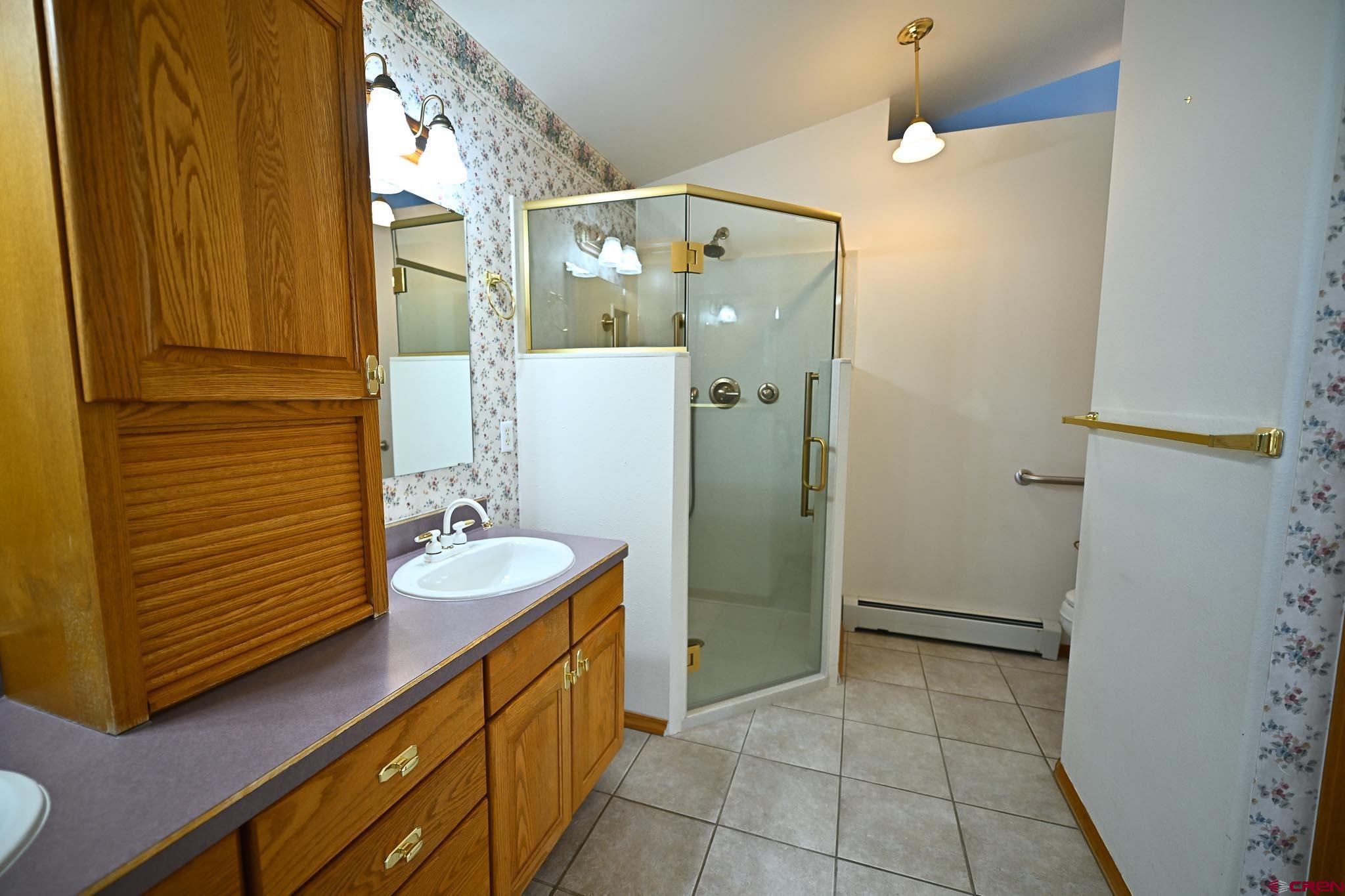 66750 Solar Road Montrose, CO 81403 - Photo 31 of 45 a bathroom with a sink a mirror and shower