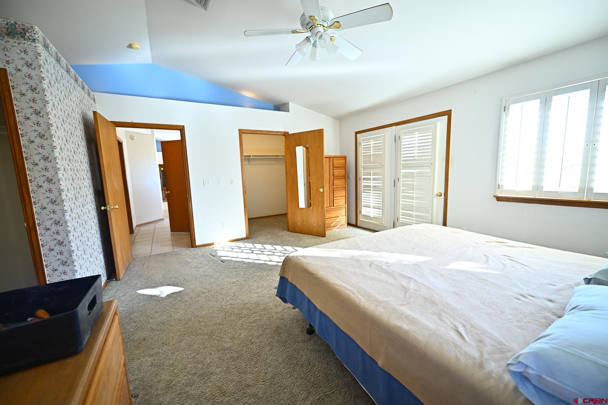 66750 Solar Road Montrose, CO 81403 - Photo 35 of 45 a spacious bedroom with a large bed and a window