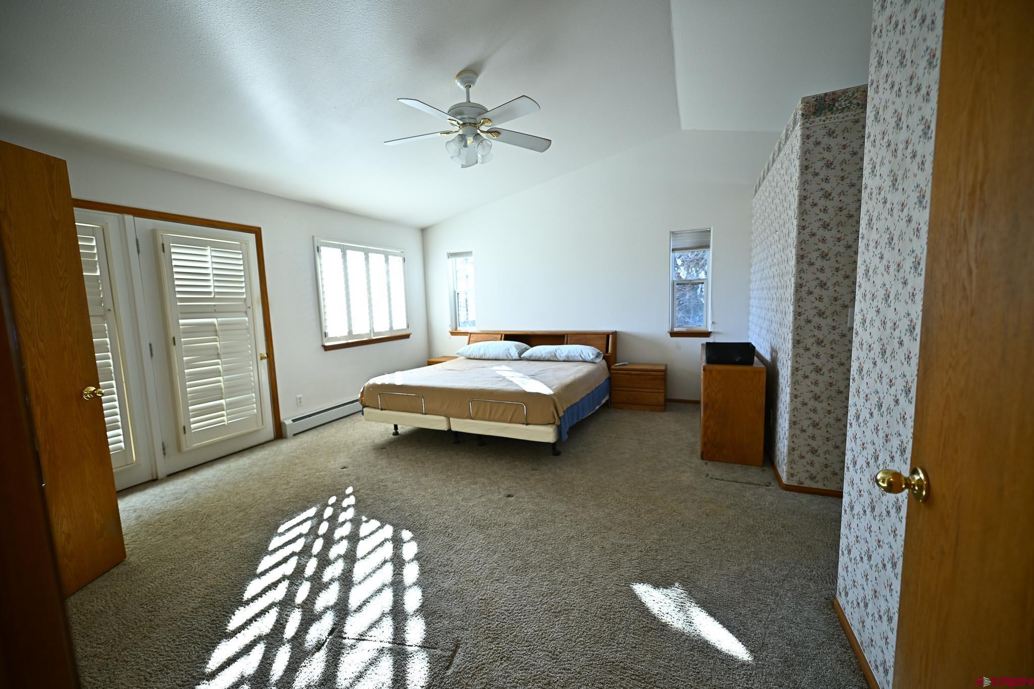66750 Solar Road Montrose, CO 81403 - Photo 36 of 45 a bedroom with a bed and a chandelier