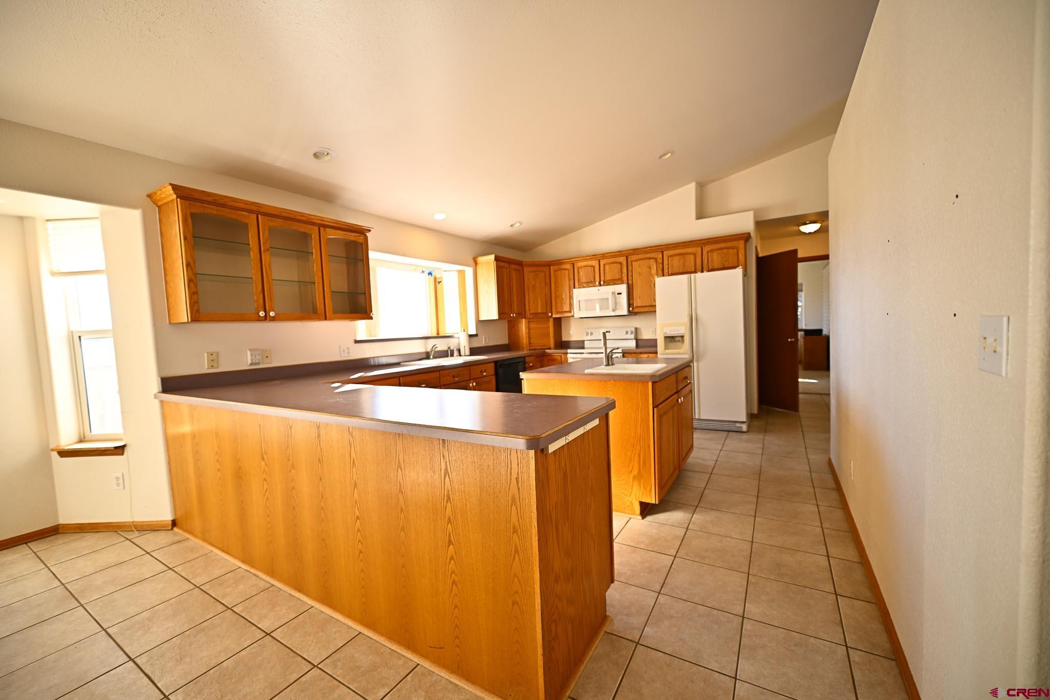 66750 Solar Road Montrose, CO 81403 - Photo 44 of 45 a kitchen with stainless steel appliances granite countertop a refrigerator and a sink