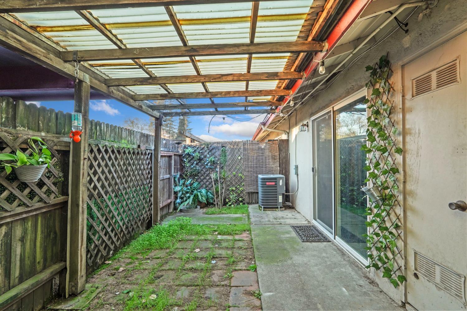 6103 Plymouth Road, Unit 1974 Stockton, CA 95207 - Photo 13 of 13 a view of a porch with plants and a porch