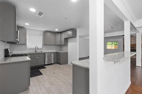 a kitchen with a sink a stove a refrigerator and a window