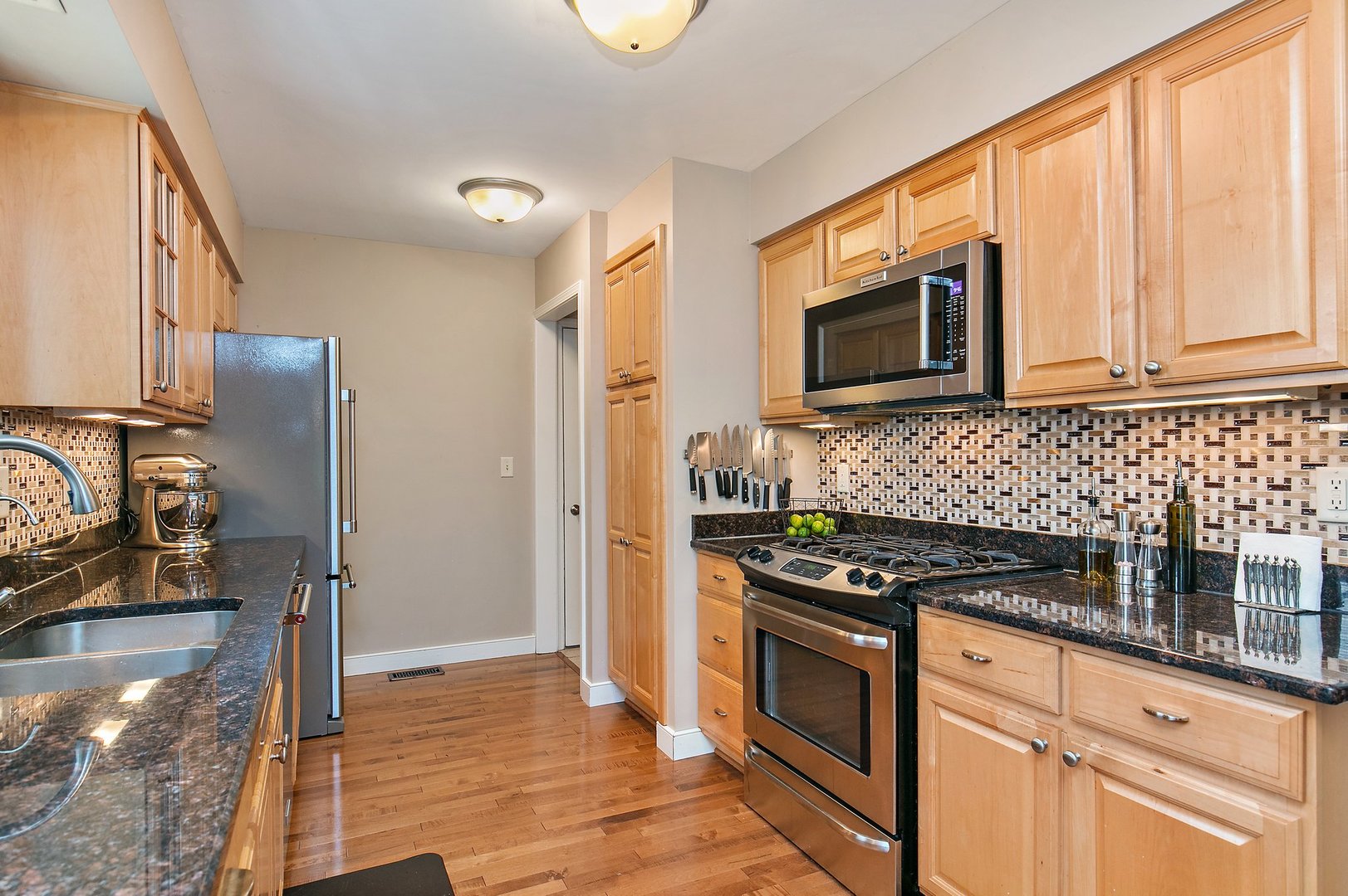 606 Old Hunt Road Fox River Grove, IL 60021 - Photo 13 of 35 a kitchen with granite countertop a stove and a microwave