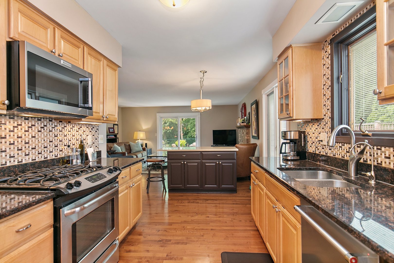 606 Old Hunt Road Fox River Grove, IL 60021 - Photo 14 of 35 a kitchen with stainless steel appliances granite countertop a stove a sink and a microwave
