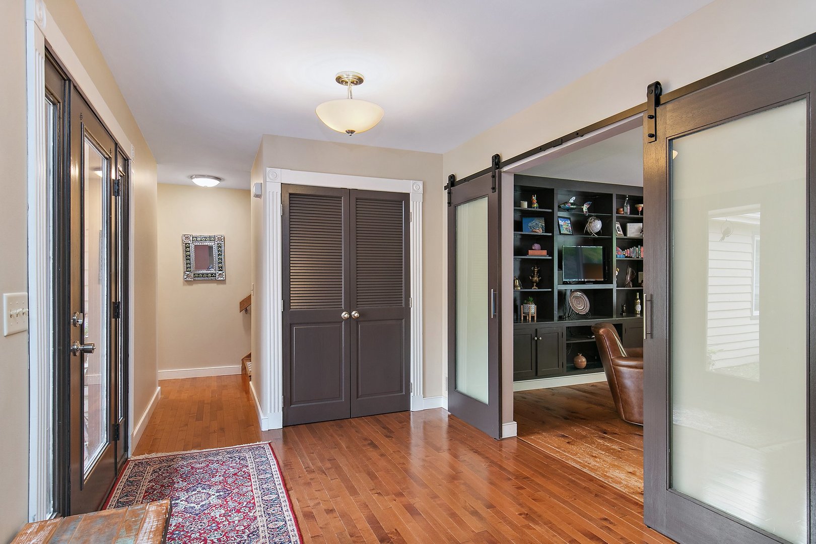 606 Old Hunt Road Fox River Grove, IL 60021 - Photo 4 of 35 a view of a hallway with wooden floor and closet