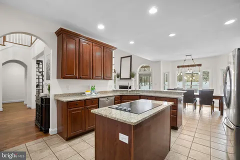 a kitchen with white cabinets and a stove top oven