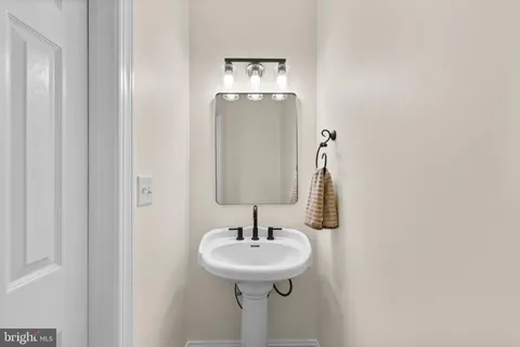 a bathroom with a sink mirror and toilet