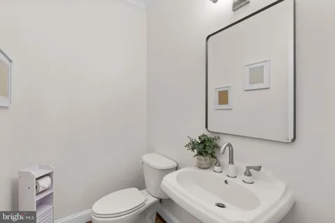 a bathroom with a granite countertop double vanity sink mirror and shower