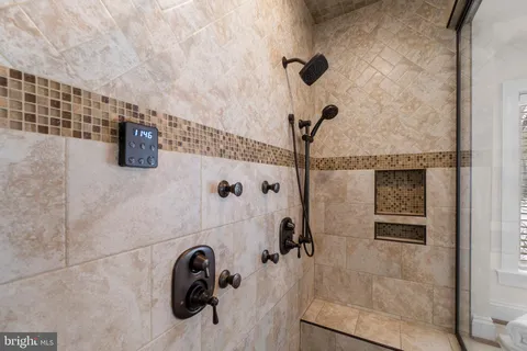 a spacious bedroom with a bed and wooden floor