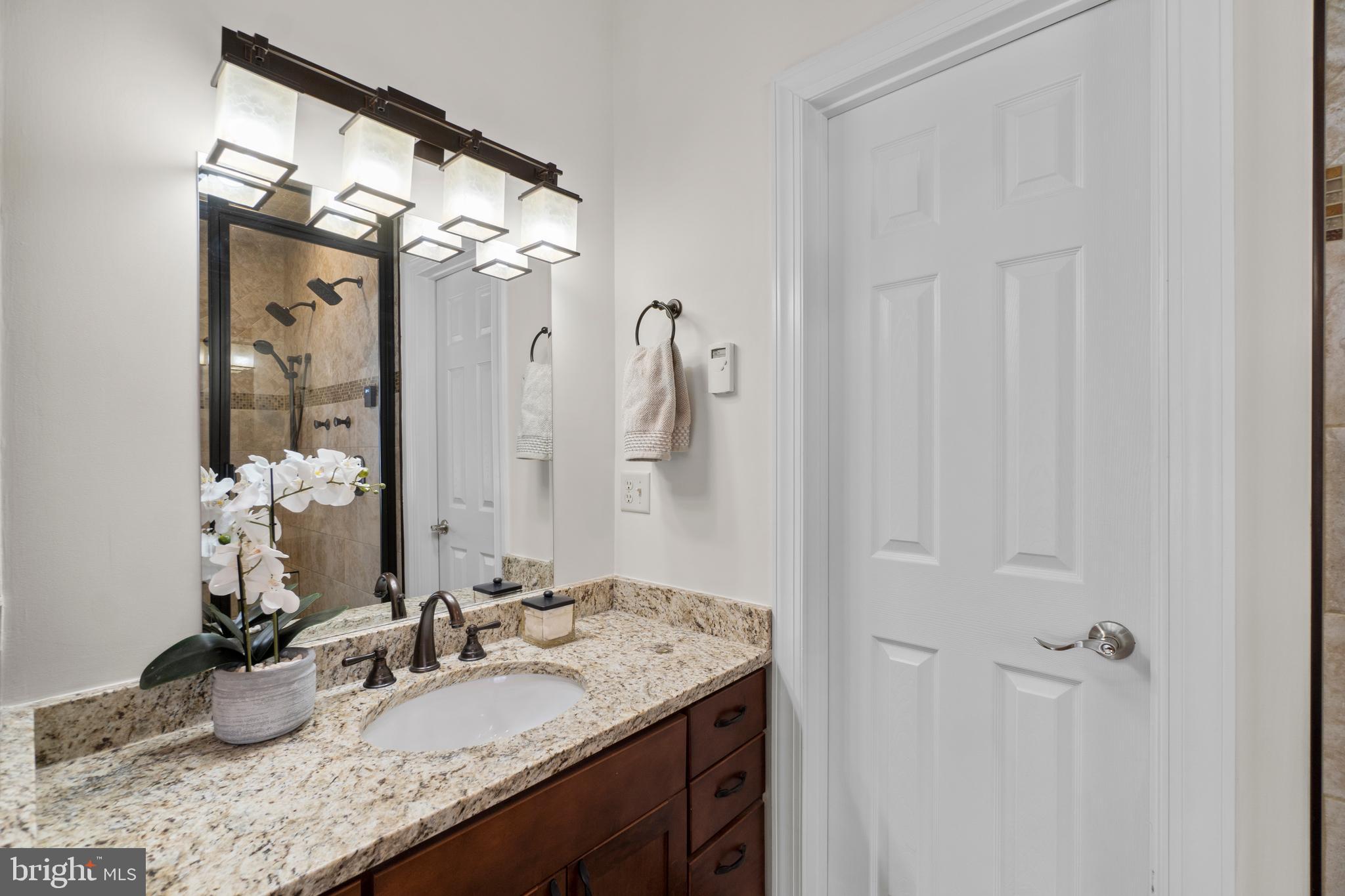 21877 Boonsboro Mountain Road Boonsboro, MD 21713 - Photo 30 of 63 a bathroom with a granite countertop sink and a mirror