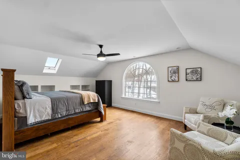 a bedroom with a bed and a ceiling fan