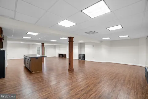 a front view of a house with swimming pool and sitting area