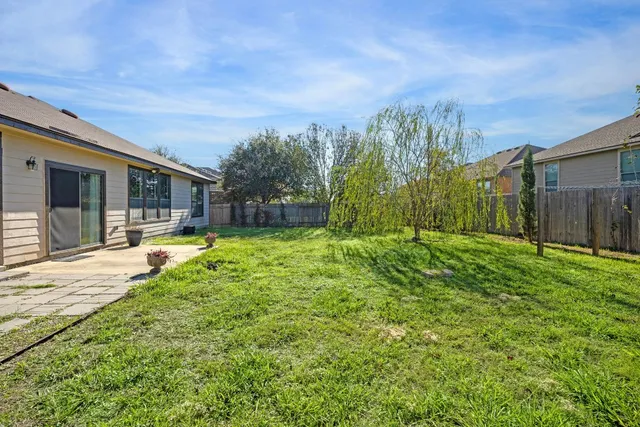 a swimming pool with outdoor seating and yard
