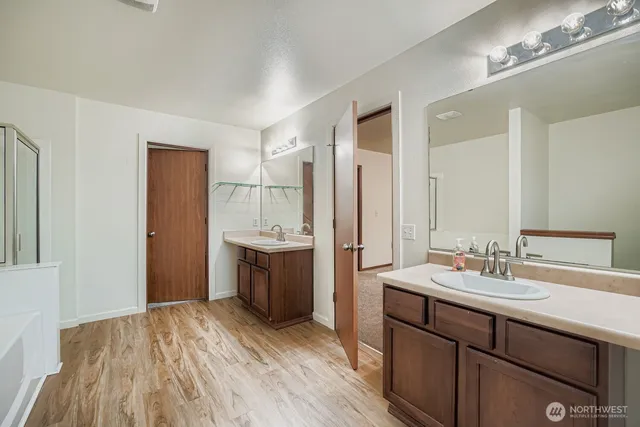 a bathroom with a sink a mirror and a bathtub