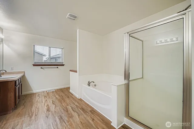 a bathroom with a bathtub and a shower