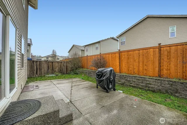 a backyard of a house with table and chairs