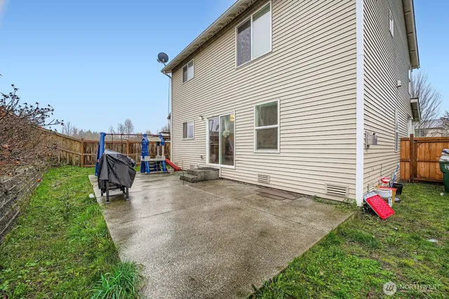 a backyard of a house with table and chairs