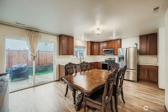 a view of a dining room with furniture and wooden floor